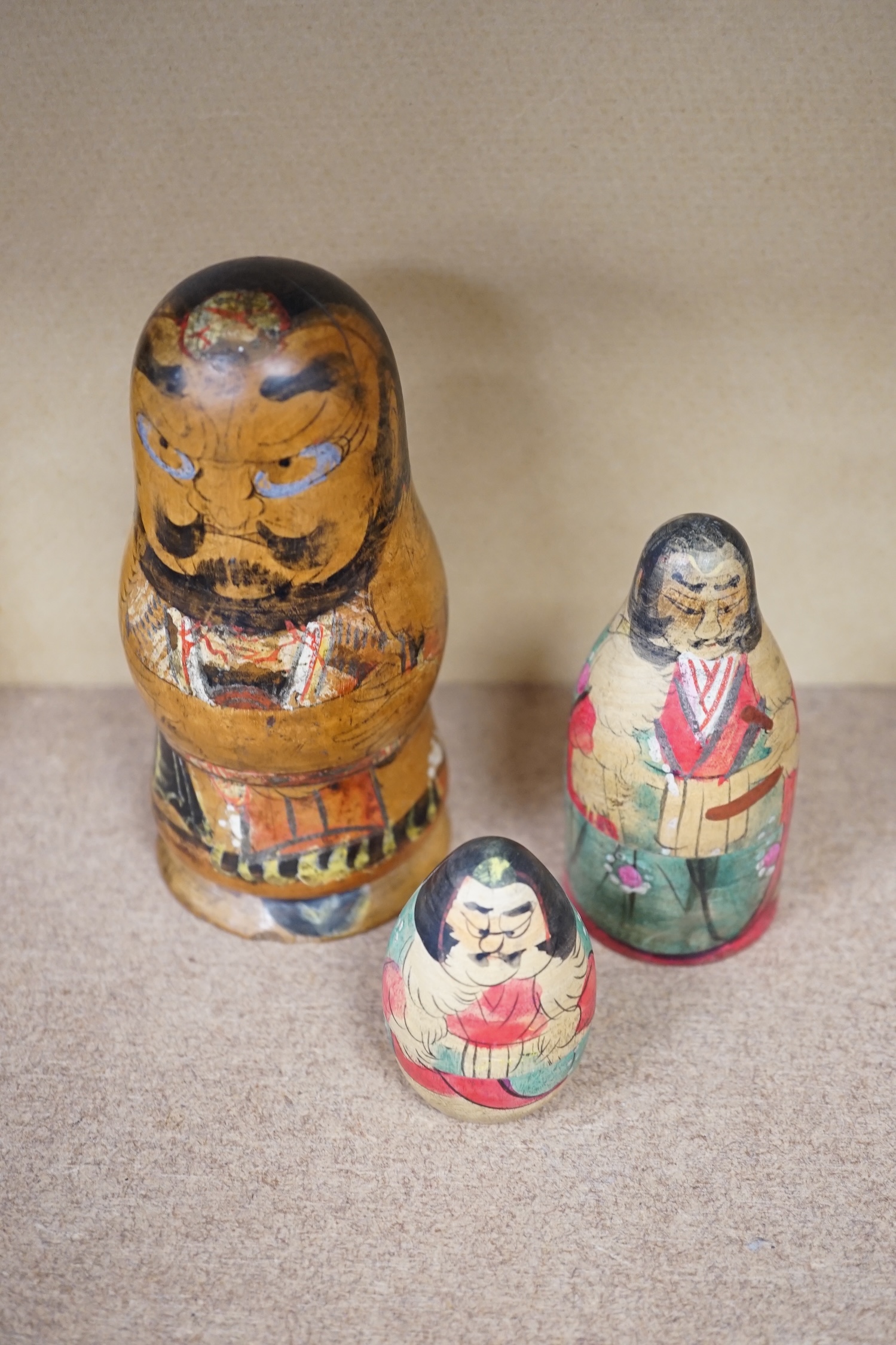 A nest of three Japanese decorated Russian dolls. Condition - fair